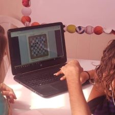 School girls working on their homework digitally