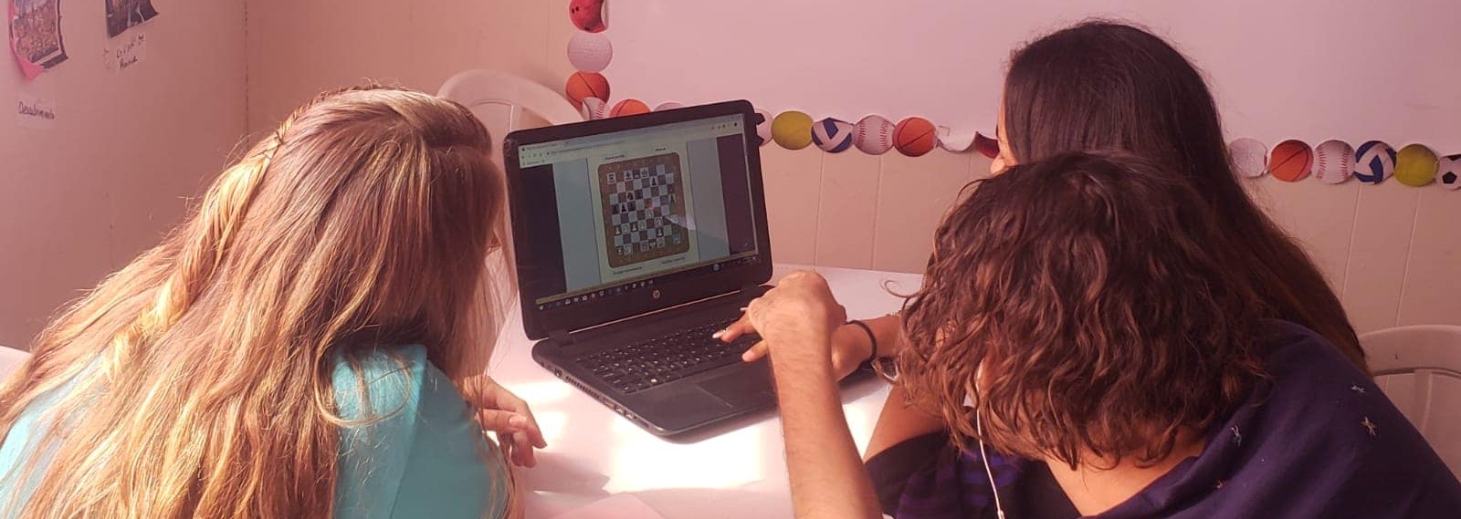 School girls working on their homework digitally