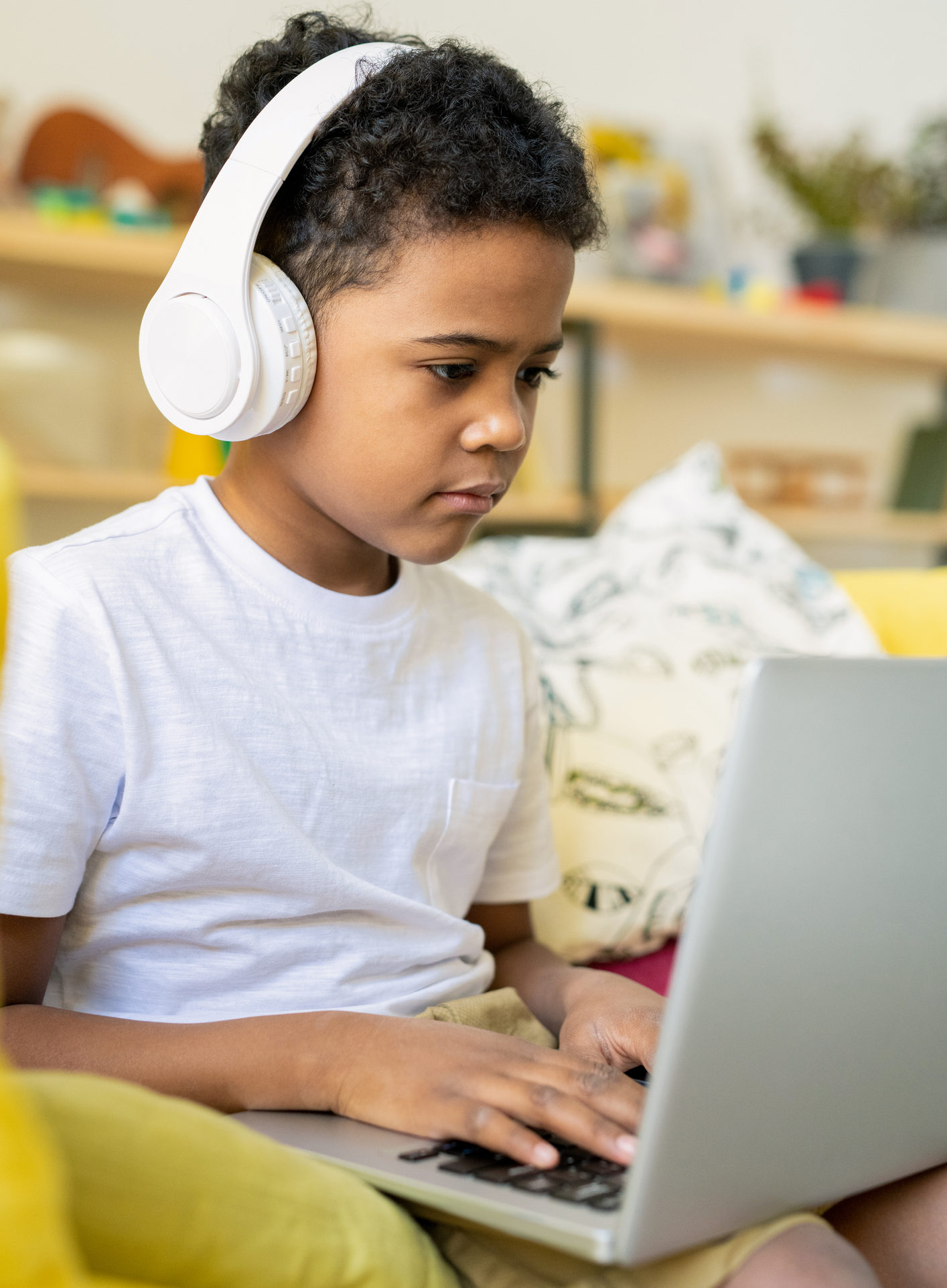 School kid working on homework on his laptop