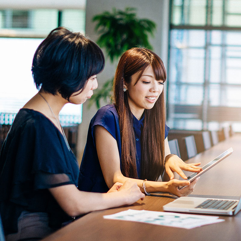 women in office on tablet