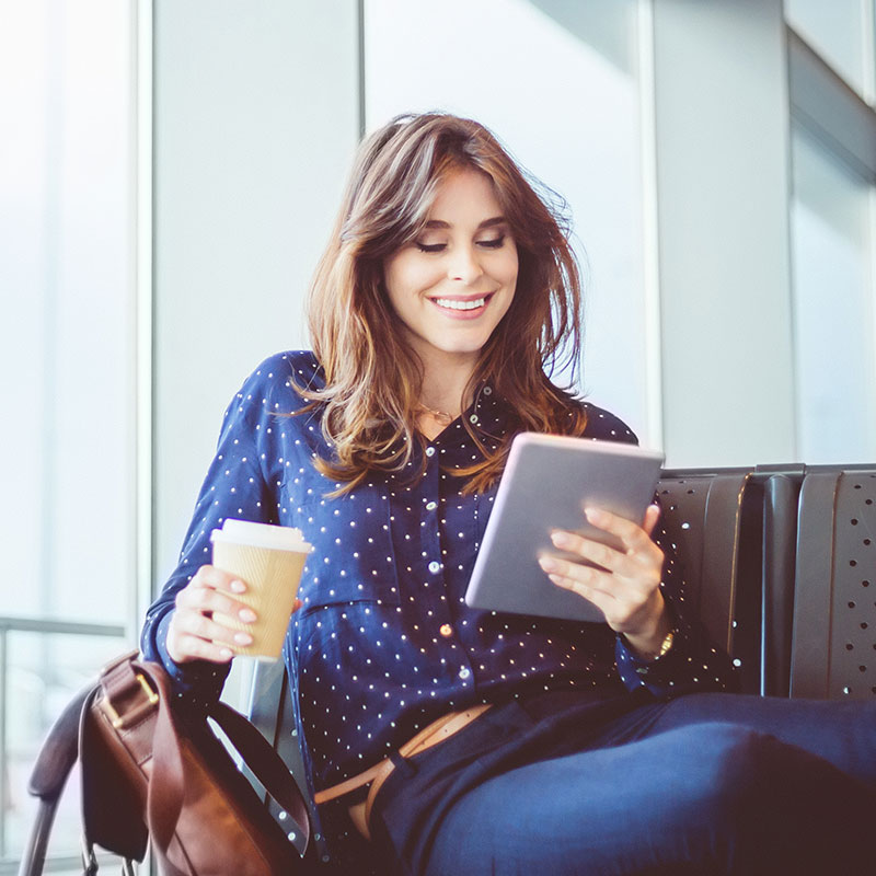 Woman using a tablet in a public setting