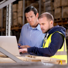 Men working in warehouse using wifi