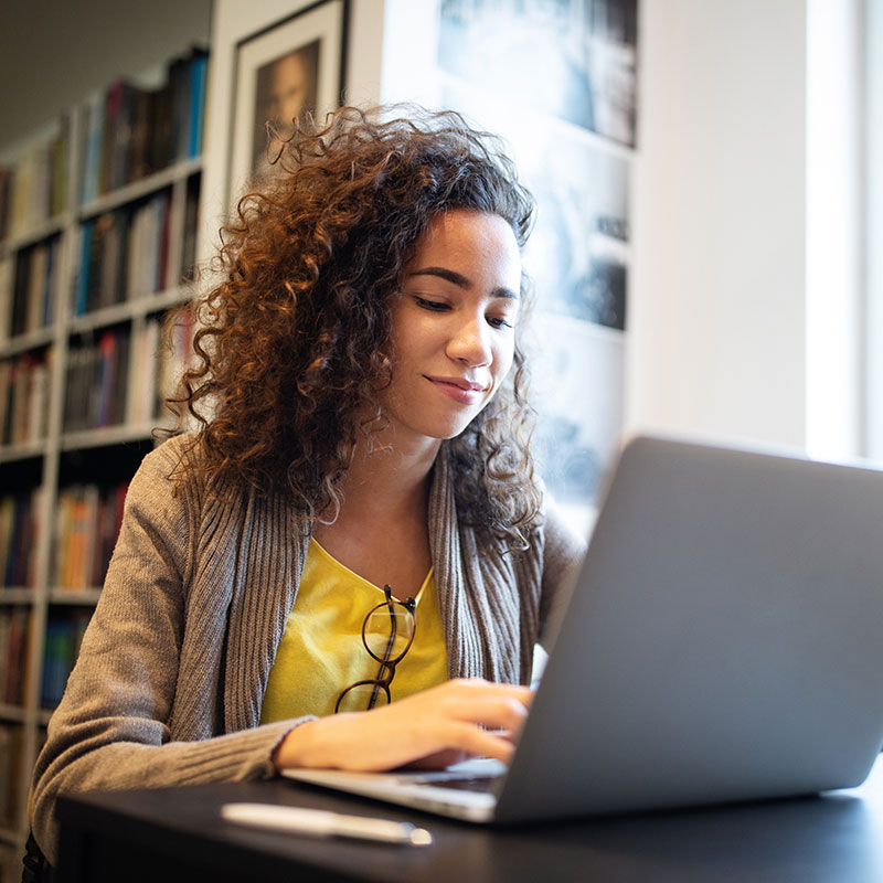 Excellent customer experiences provided by broadband service provider operators. Image of a woman working on her laptop