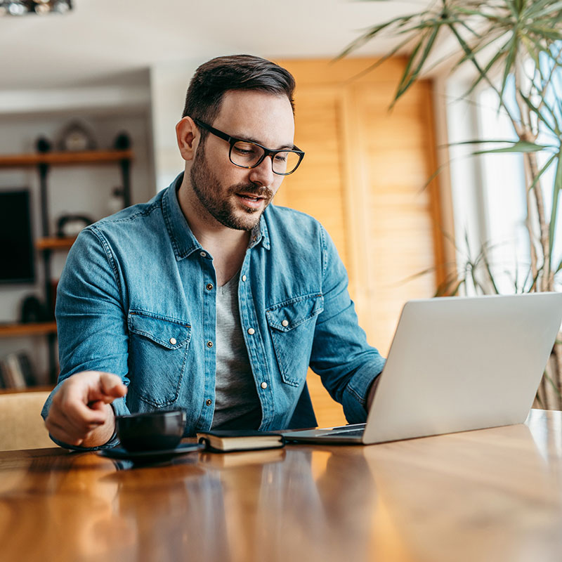 Image of a man working on his laptop.